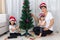 Asian Chinese mother and daughters decorating Christmas tree at