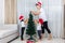 Asian Chinese mother and daughters decorating Christmas tree at