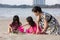 Asian Chinese mum and daughters playing sand together