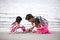 Asian Chinese mum and daughters playing sand together