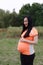 Asian Chinese pregnant woman in yoga dress embrace hug nature have fresh air enjoy peaceful life relax meditation in forest garden