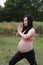 Asian Chinese pregnant woman in yoga dress in nature forest meditation do exercise workout keep healthy manage weight