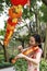 Asian Chinese woman artist in traditional chi-pao cheongsam in a garden play musical instruments violin art on Mid-autumn Festival