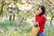 Asian Chinese woman beauty girl in a flower field in a spring summer autumn park smell fruit orange enjoy cozy life