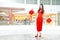 Asian Chinese woman in a cheongsam dress holding Chinese lantern