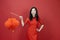 Asian chinese woman in red cheongsam or qipao holding denglong the paper lantern to wish the good luck and prosperity in Chinese