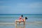 Asian chinese woman spending time playing with daughter at the beach