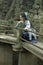 Asian Chinese woman in traditional Blue and white Hanfu dress, play in a famous garden Climb on the bent bridge