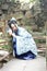 Asian Chinese woman in traditional Blue and white Hanfu dress, play in a famous garden Climb on the bent bridge