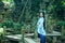 Asian Chinese woman in traditional Blue and white Hanfu dress, play in a famous garden on crooked Bridge