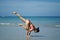 Asian Chinese Woman in various yoga poses at the beach