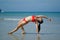 Asian Chinese Woman in various yoga poses at the beach