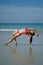 Asian Chinese Woman in various yoga poses at the beach