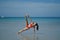 Asian Chinese Woman in various yoga poses at the beach