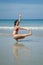 Asian Chinese woman in various yoga poses at the beach