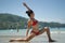 Asian Chinese woman in various yoga poses at the beach