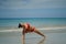 Asian Chinese Woman in various yoga poses at the beach