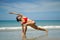 Asian Chinese Woman in various yoga poses at the beach