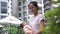 Asian chinese young mother with her newborn child by the swimming pool