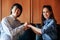 Asian Christian woman and man smiling join hands in praying for Jesus` blessings to show love and confession of their sins