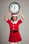 Asian Christmas girl in Santa Claus clothes and clock at midnight