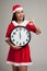 Asian Christmas girl in Santa Claus clothes and clock at midnight