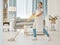 Asian cleaner woman mopping and cleaning dirt and dust in lounge or living room floor in house or home. Happy Japanese