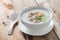 Asian congee with minced pork in white bowl.