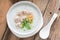 Asian congee with minced pork in white bowl. Top view.