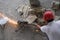 Asian Construction Worker Cutting Metal Sparks