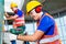 Asian construction workers drilling in building walls