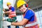 Asian construction workers drilling in building walls