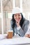 Asian contractor in formal wear holding coffee cup and looking at camera