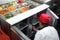 Asian cook in a citchen working on a vegetable buffet bar