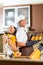 Asian couple baking muffins in home kitchen