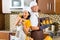 Asian couple baking muffins in home kitchen