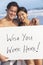 Asian Couple at Beach Wish You Were Here Sign