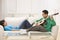 Asian couple on couch relaxing together.