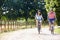 Asian Couple On Cycle Ride In Countryside