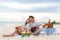 Asian couple happy and enjoy the trip honeymoon of couple lover on the sea beach by playing Ukulele and singing song music