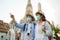 Asian couple happy tourists to travel on they holidays and holding in Wat Arun Temple in Bangkok, Thailand