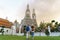 Asian couple happy tourists to travel on they holidays and holding in Wat Arun Temple in Bangkok, Thailand