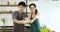 Asian couple held plate of pasta to the camera.