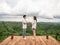 Asian couple holding hands on wooden balcony with mountain view. Mariage proposal concept. terrace for camping tent with landscape