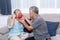 Asian couple, husband helping his wife wear a mask made of cloth, to protect against dusà¸° and germs