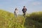 Asian couple jogging together, outdoor morning run in nature trail organic rice paddy field. Healthy lifestyles and sustainability