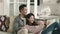asian couple looking at cellphone picture together at home