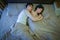 Asian couple in love, sleeping together on bed at night