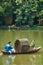 Asian couple rowing small boat