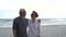 Asian couple senior elder retire resting relax walking at sunset beach honeymoon